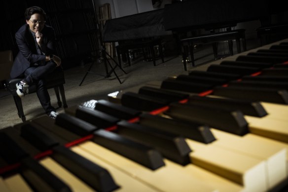 Pianist/composer Charlie Chan watches on as a Yamaha piano plays in exactly their own style, thanks to AI. 