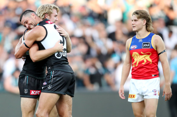 Happy Port days: Jason Horne-Francis hugs a teammate as Will Ashcroft looks on.