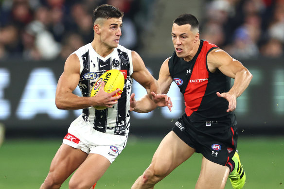 Collingwood star Nick Daicos evades Essendon’s Dylan Shiel.