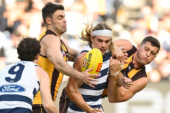 Bailey Smith is in the middle of the challenge against Conor Nash and Lloyd Meek in last year's Easter Monday clash between Hawthorn and Geelong.