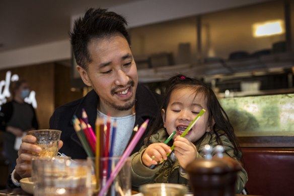 Christopher Ong and daughter Ava, 3, enjoy a coffee at Northcote cafe Bicycle Thieves as Melbourne emerges from its latest lockdown.