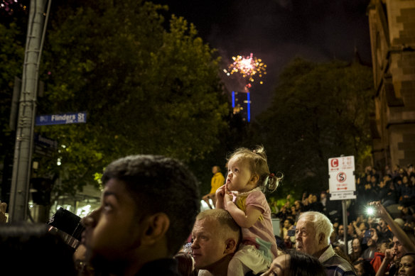 Revellers watch the 2019 New Year’s Eve fireworks from Flinders Street.