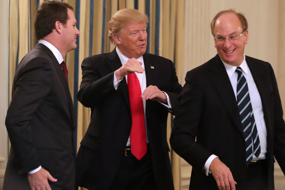 BlackRock chief Larry Fink (right) with US President Donald Trump and Wal-Mart chief Doug McMillon at the White House in 2017.