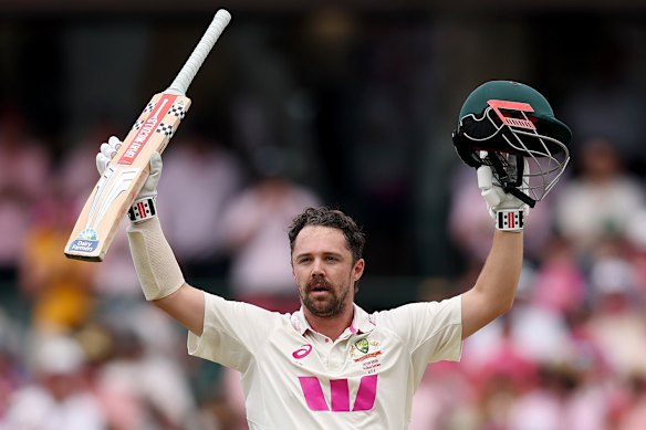 Travis Head raises his bat, and helmet, after scoring yet another Ashes ton.