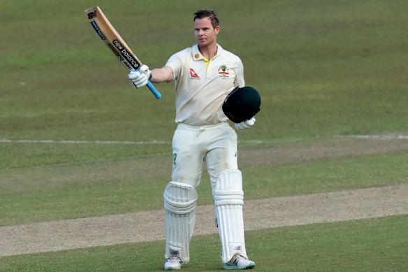 Steve Smith raises his bat after his century.