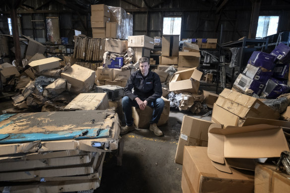 Aftershock PC co-owner Richard Noble surrounded by damaged computer parts.