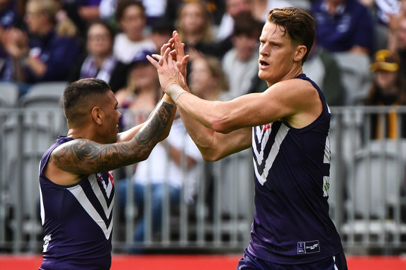 Matt Taberner (right) and Michael Walters celebrate a goal against the Hawks at Optus Stadium.