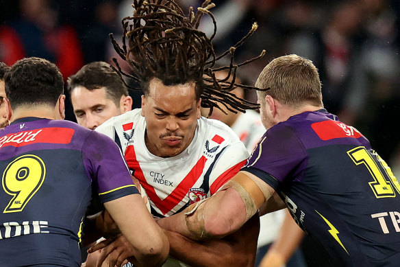 Roosters winger Dominic Young braces for contact as the Storm make a two-man tackle.