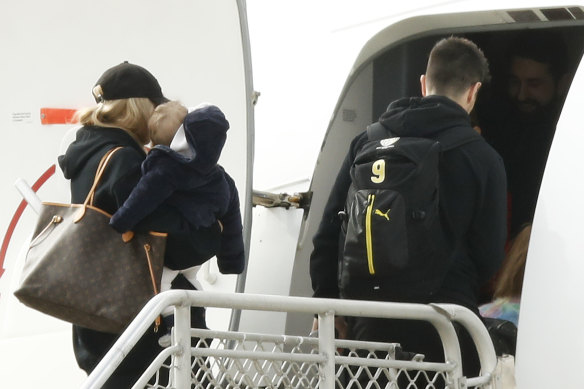 Richmond's Trent Cotchin and his family board a flight to Queensland earlier this month.
