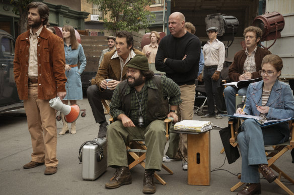 Miles Teller (seated, left) as Al Ruddy and Dan Fogler (seated, front) as Francis Ford Coppola in The Offer.