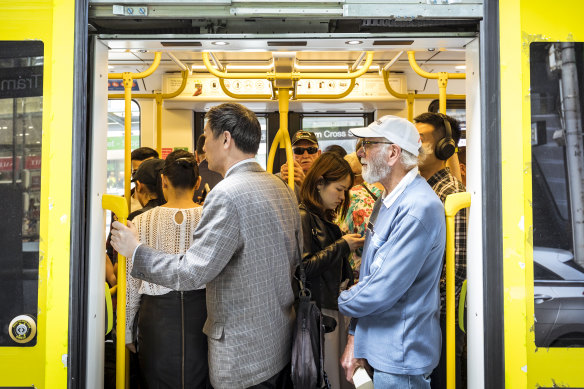Commuters pack into a crowded tram along Bourke Street during the lunchtime break earlier this year.