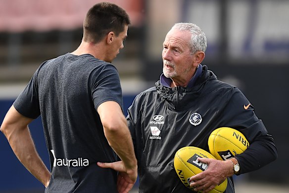 Robert Walls with Carlton player Matthew Kreuzer at Blues training in 2019.