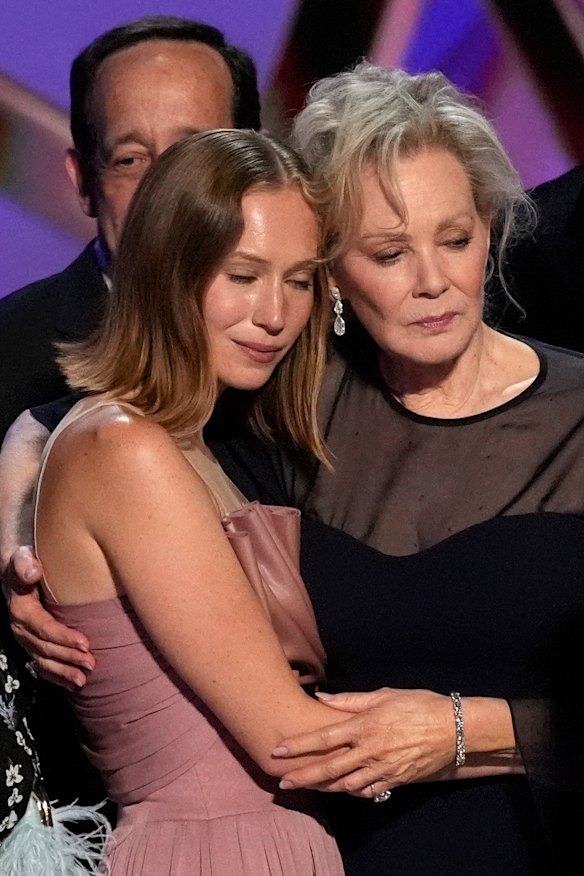 Hacks costars Hannah Einbinder and Jean Smart embrace on stage.