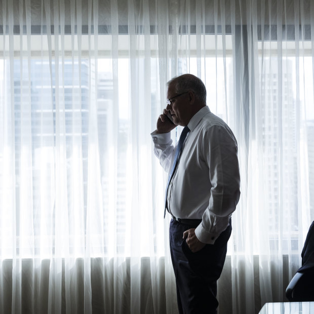 Scott Morrison on the phone to wife Jenny during a break in his Brisbane hotel room.