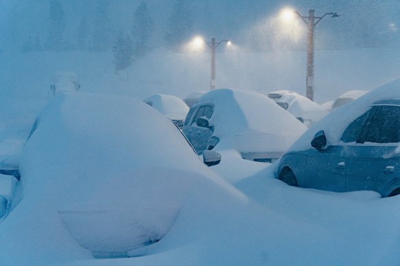 Snow covers vehicles at the Mammoth Mountain Ski Area in Mammoth Lakes, California.