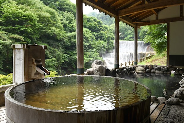 Onsen water runs out of a wooden tap at Tsuchiyu Onsen's Sansuiso Hotel in Fukushima prefecture.
