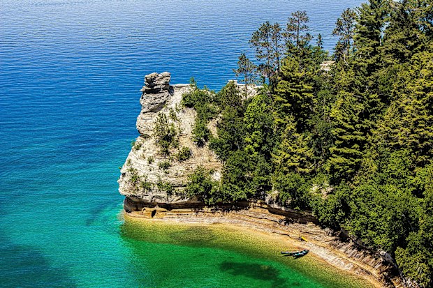 The cliffs at Pictured Rocks National Lakeshore feature natural arches, half-sunken caves, waterfalls and stunning rock formations like Miners Castle, seen here.
