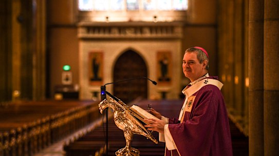 Melbourne Catholic Archbishop Peter Comensoli preparing to give the homily at the 11am morning mass to empty pews at St Patrick's Cathedral in East Melbourne. The service will be live streamed due to the restrictions on religious services due to the coronavirus pandemic. 