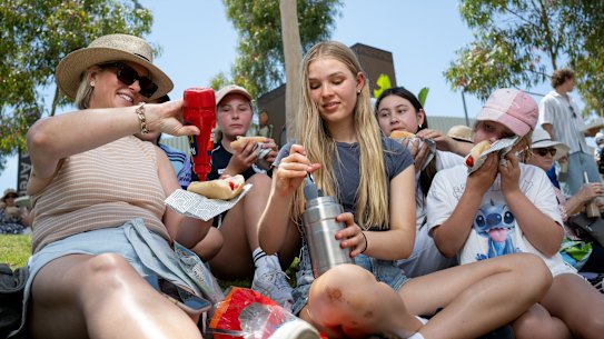 Katrina Langdon and daughter Eliza serve home-brought hot dogs to the children she took to the Australian Open.