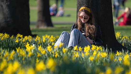 A woman enjoys the London sun.