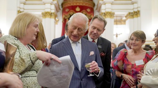 King Charles speaks to guests at the reception on Wednesday.