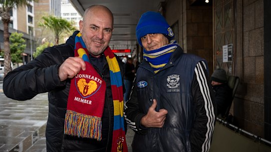 Brisbane Lions fan Chris Walkley and Geelong Cats fan Joesph Merca waiting in line for tickets.