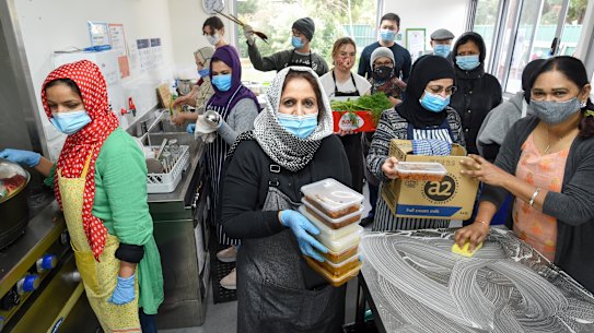 Afshan Mantoo (centre) and her group of volunteers preparing food at their kitchen in Coburg.