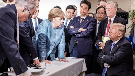   In this photo provided by the German Government Press Office (BPA), German Chancellor Angela Merkel deliberates with US president Donald Trump on the sidelines of the official agenda on the second day of the G7 summit on June 9, 2018 in Charlevoix, Canada. Also pictured are (L-R) Larry Kudlow, director of the US National Economic Council, Theresa May, UK prime minister, Emmanuel Macron, French president, Angela Merkel, Yasutoshi Nishimura, Japanese deputy chief cabinet secretary, Shinzo Abe, Japan prime minister, Kazuyuki Yamazaki, Japanese senior deputy minister for foreign affairs, John Bolton, US national security adviser, and Donald Trump. Canada are hosting the leaders of the UK, Italy, the US, France, Germany and Japan for the two day summit.  