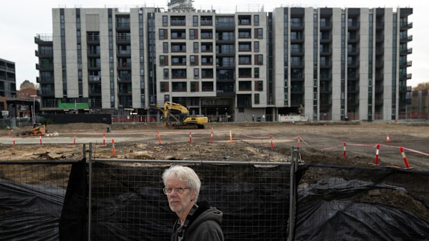 Long-time Kensington resident Simon Harvey stands near some of the Macaulay Road build-to-rent projects.