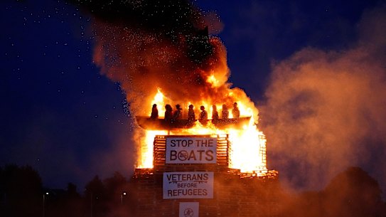 Effigies of migrants in a boat burn atop a bonfire at Moygashel, County Tyrone, Northern Ireland, ahead of events to mark the Twelfth of July, Thursday July 10, 2025. (Niall Carson/PA via AP)