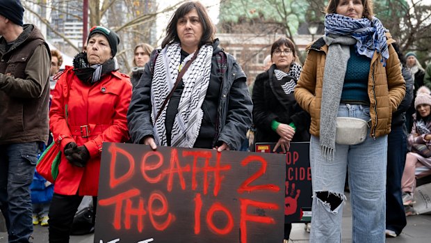 A protester holds a “Death 2 the IOF [Israeli occupation force]” sign.