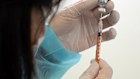 A health worker prepares a dose of the Pfizer COVID-19 vaccine.  Pfizer paid $43 mln in Australian income tax last year on $1.1 bln of sales.