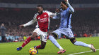Arsenal’s Raheem Sterling and Tottenham Hotspur’s Djed Spence battle for the ball at a game in London last week. The English Premier League is broadcast in Australia by Optus, which is considering selling its streaming service.