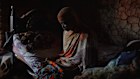 Fatma Swak Fadul holds a shirt that belonged to her three-year-old son Omer, who starved to death at home in Mayo Mandala on the outskirts of Omdurman, Sudan, in March. His 18-month-old sister died from starvation the month before.