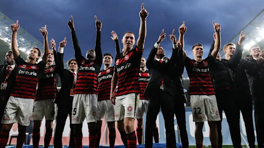 Mitchell Duke of the Wanderers leads his teammates in celebrations at Bankwest Stadium.
