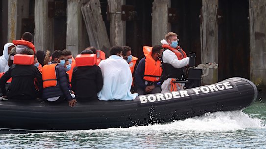 A British Border Force vessel carries a group of men thought to be migrants into Dover harbour, Southern England, last week. 