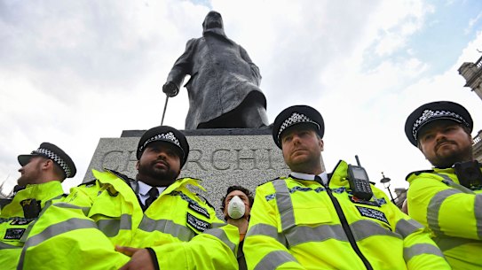 Police surround a Winston Churchill statue during a Black Lives Matter rally in London last week.  
