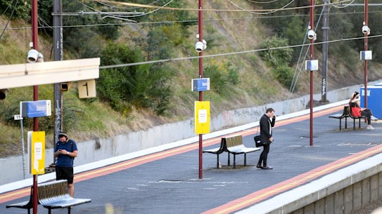Melbourne commuters wait on a  platform at Elsternwick railway station on Monday morning.