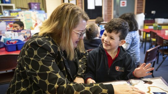 Education Minister Natalie Hutchins with prep student Henry at Moonee Ponds Primary School on Wednesday.