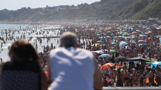 People are seen on the beach on the hottest day of the year, after an easing of social restrictions due to coronavirus, in Bournemouth, England on Wednesday, June 24. 