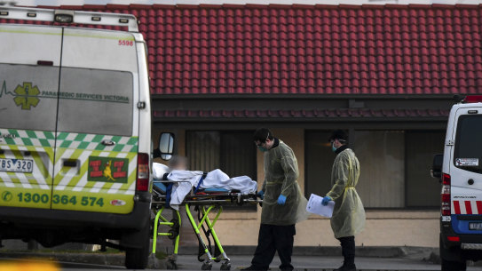 A patient is removed from St Basil's Homes for the Aged in Victoria in Fawkner on Saturday.