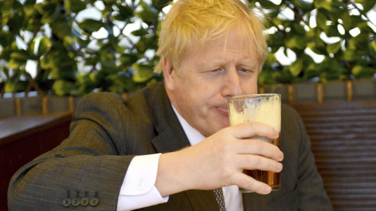 British PM Boris Johnson having a beer.