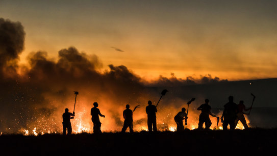 Firefighers work to contain a blaze near Bolton, England, in June 2018.