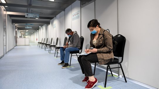 Patients Sarah and Craig wait to receive their vaccines at the Sunshine Hospital clinic.
