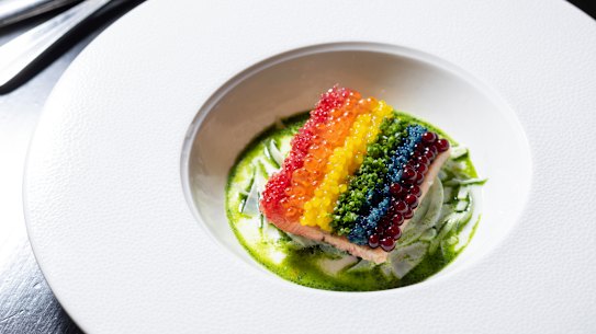 The “rainbow” trout is striped with finger lime, salmon roe, chopped chives and dashi pearls.