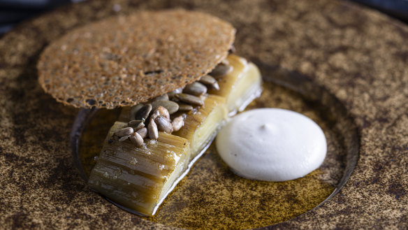 Wood-charred leek with cashew cream, brown butter and a crisp disc of chicken skin.