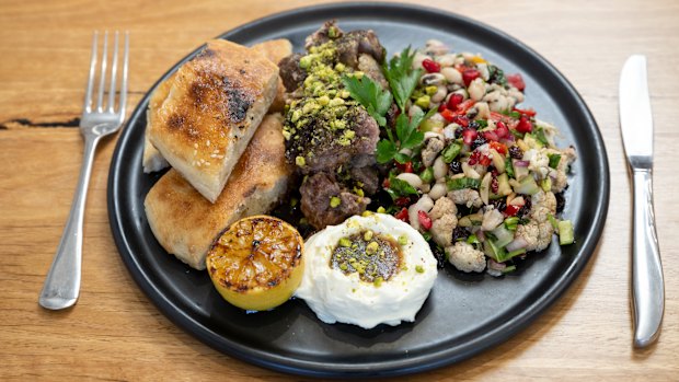 Slow-cooked lamb shoulder with labne and salad.