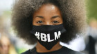 A protestor wearing a face mask to protect against coronavirus, takes part in a Black Lives Matter protest rally in Bristol, England.