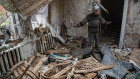 Yurii, 53, gestures as he stands in his heavily damaged house, on May 2, 2022 in Fenevychi, Ukraine. 
