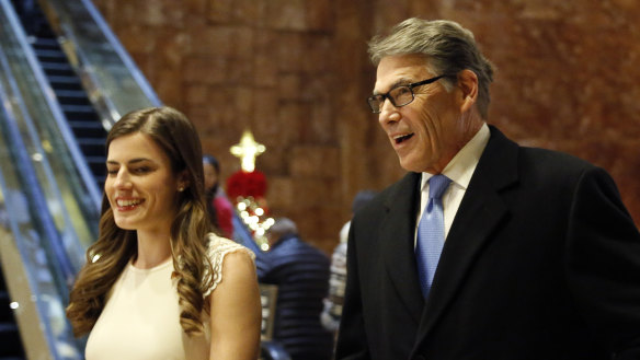 Former Texas governor Rick Perry  enters Trump Tower with Trump aide Madeleine Westerhout in 2016.